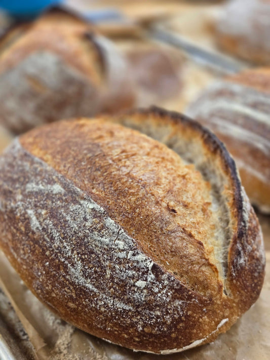 Close-up of a loaf of bread with a rustic crust.