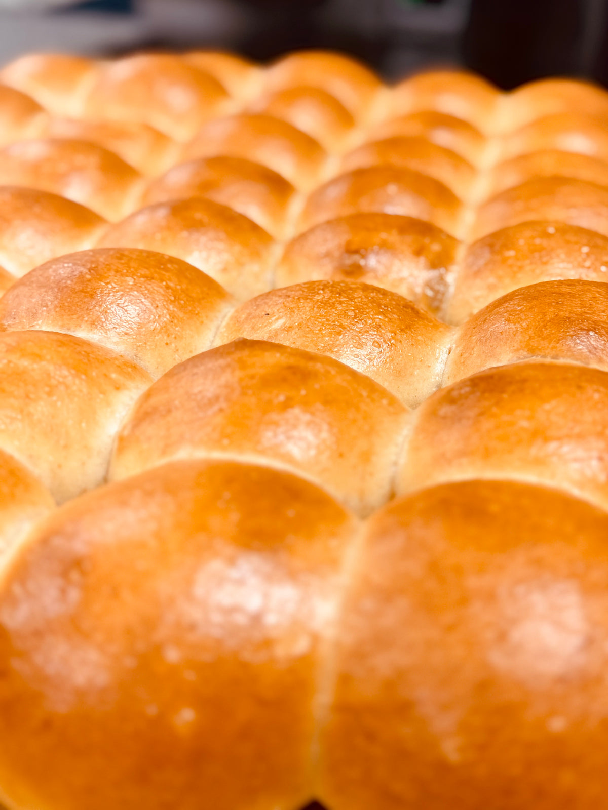 Close-up of a tray of golden brown bread rolls.